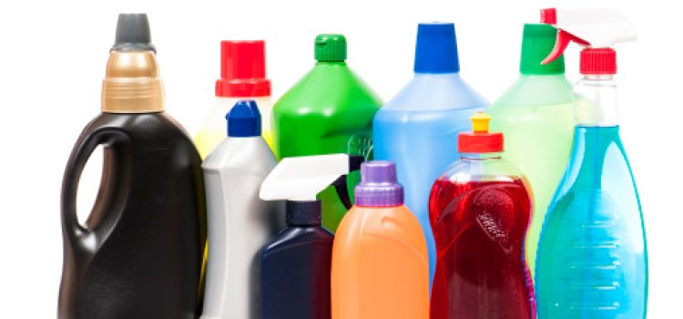 Colorful cleaning products bottles on a white background